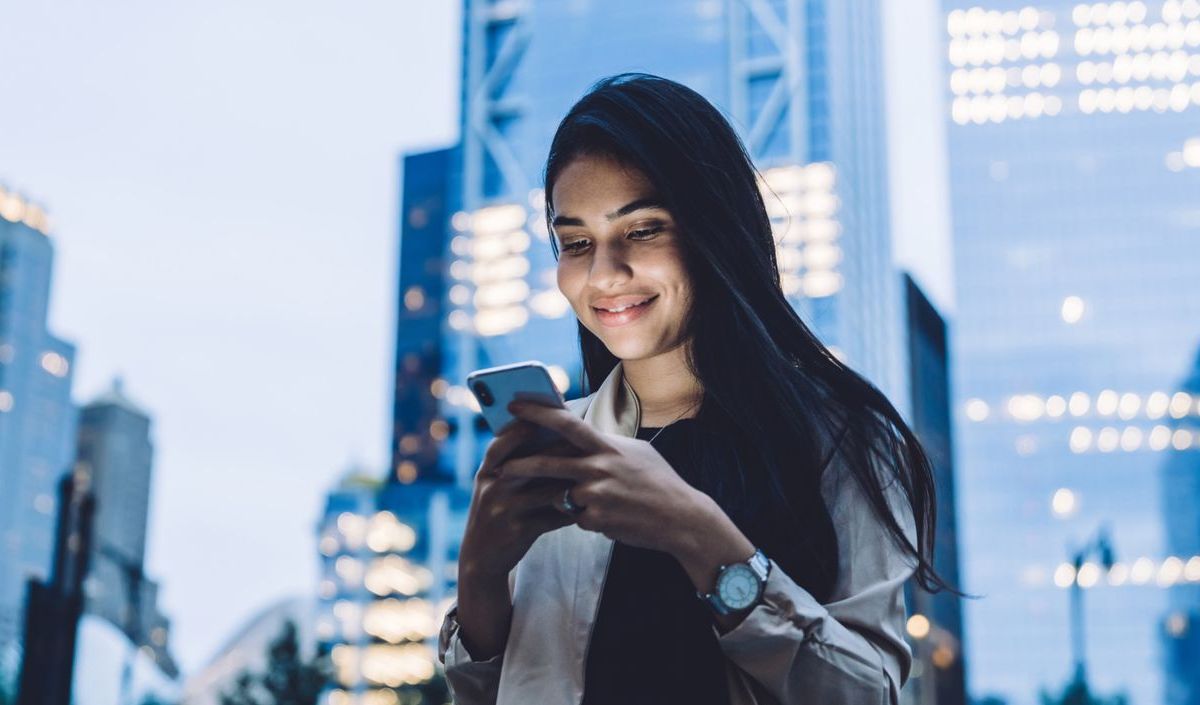 Frau hält Handy in der Hand. 