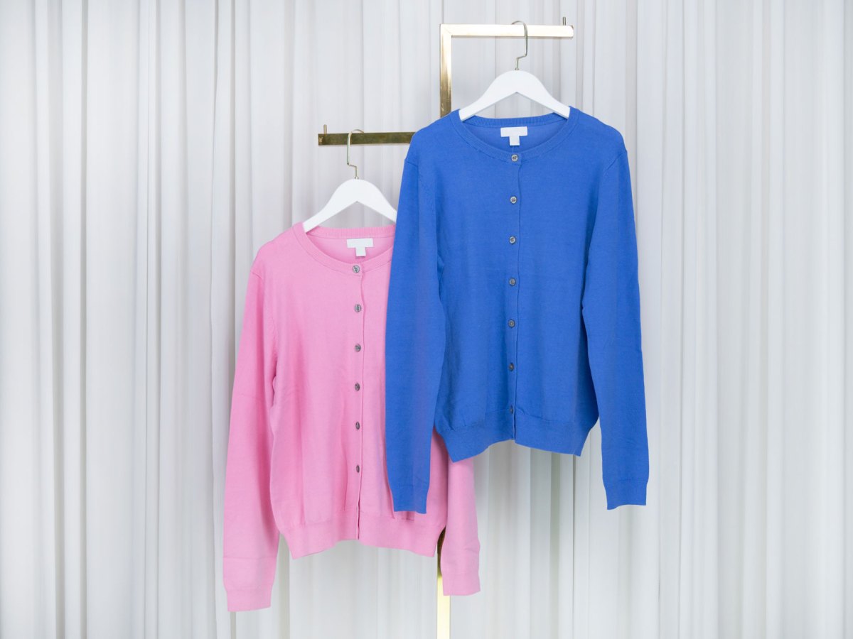 Rosa und Blaue Strickjacke auf einem Kleiderst&auml;nder