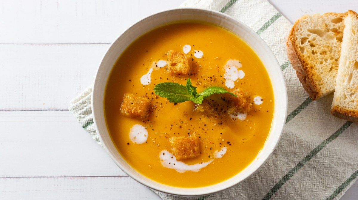 Möhrensuppe mit Croûtons in weißer Schüssel.