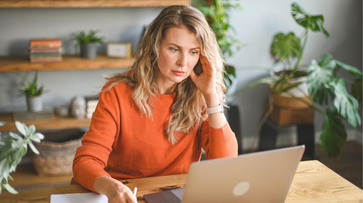 Frau sitzt vor einem Laptop.
