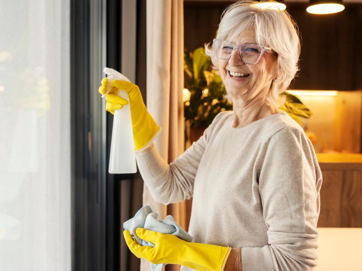 Reife Frau putzt Fenster