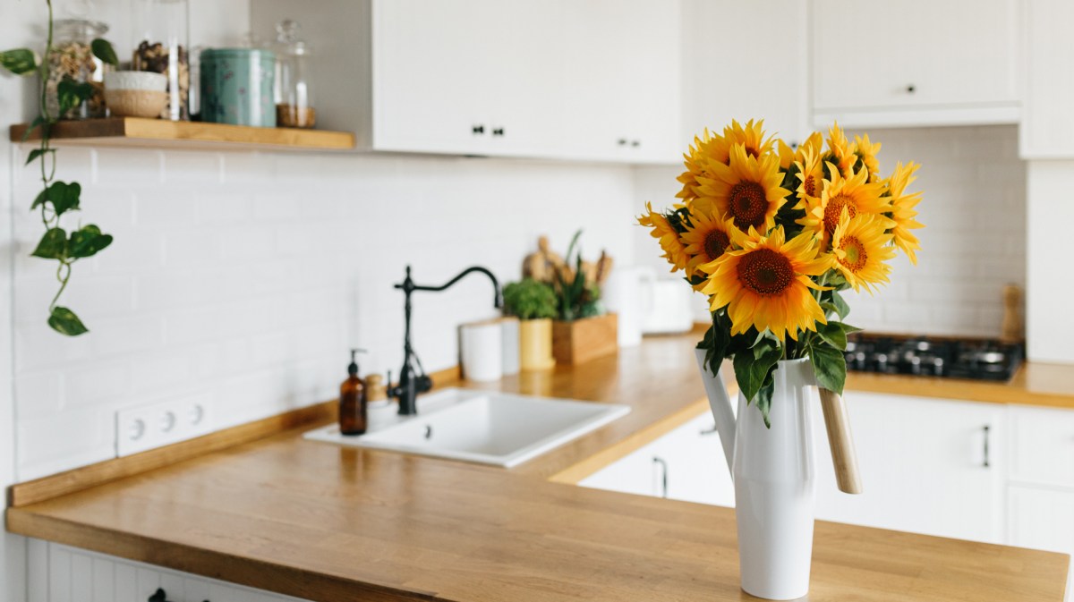 Aufgeräumte Küche mit Sonnenblumen auf dem Tresen