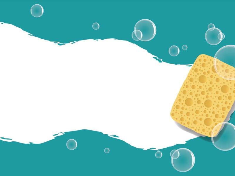 Gelber Putzschwamm wischt über nasse Oberfläche