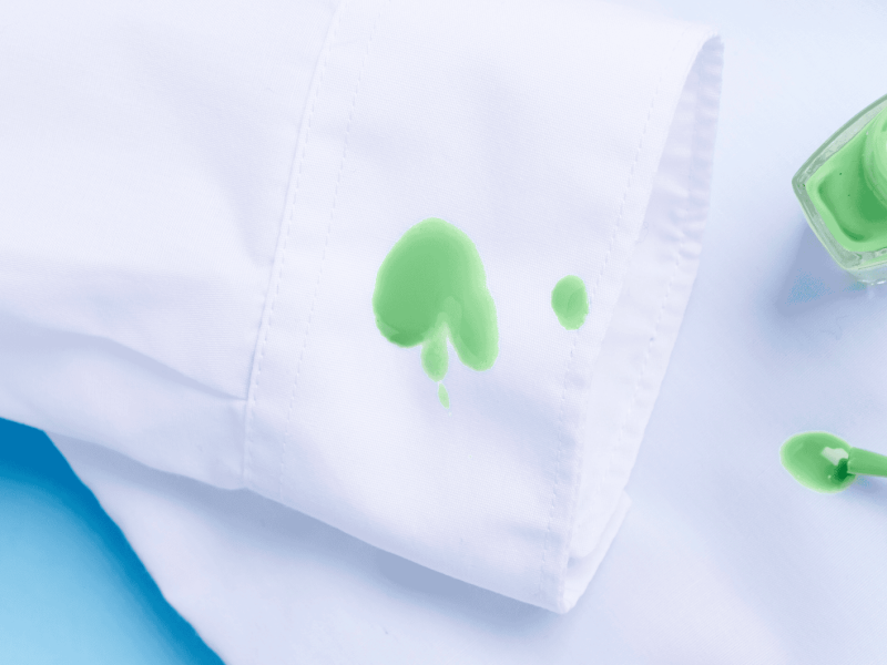 Grüner Nagellack auf einem weißen Hemd.