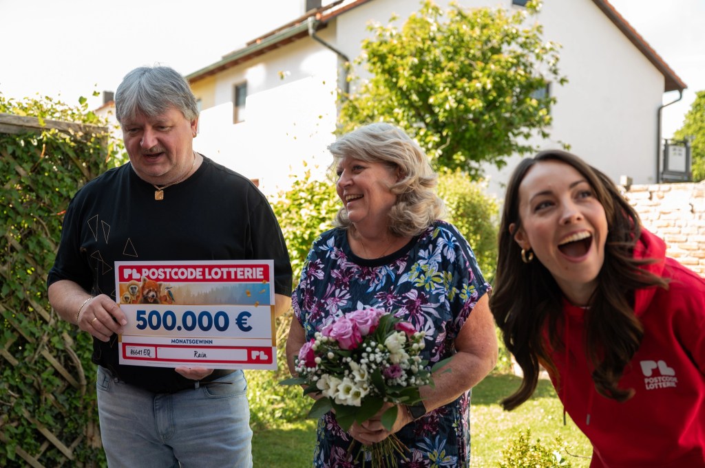 Gl&uuml;cksbotin Julia Kr&uuml;ger bei einer Gewinnbenachrichtigung mit zwei Gewinner*innen.
